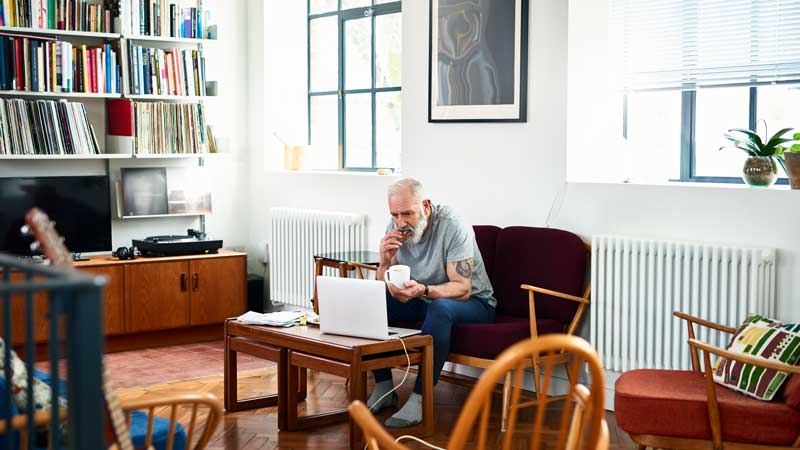 man looking at his laptop