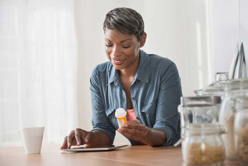 woman researching her prescription on tablet