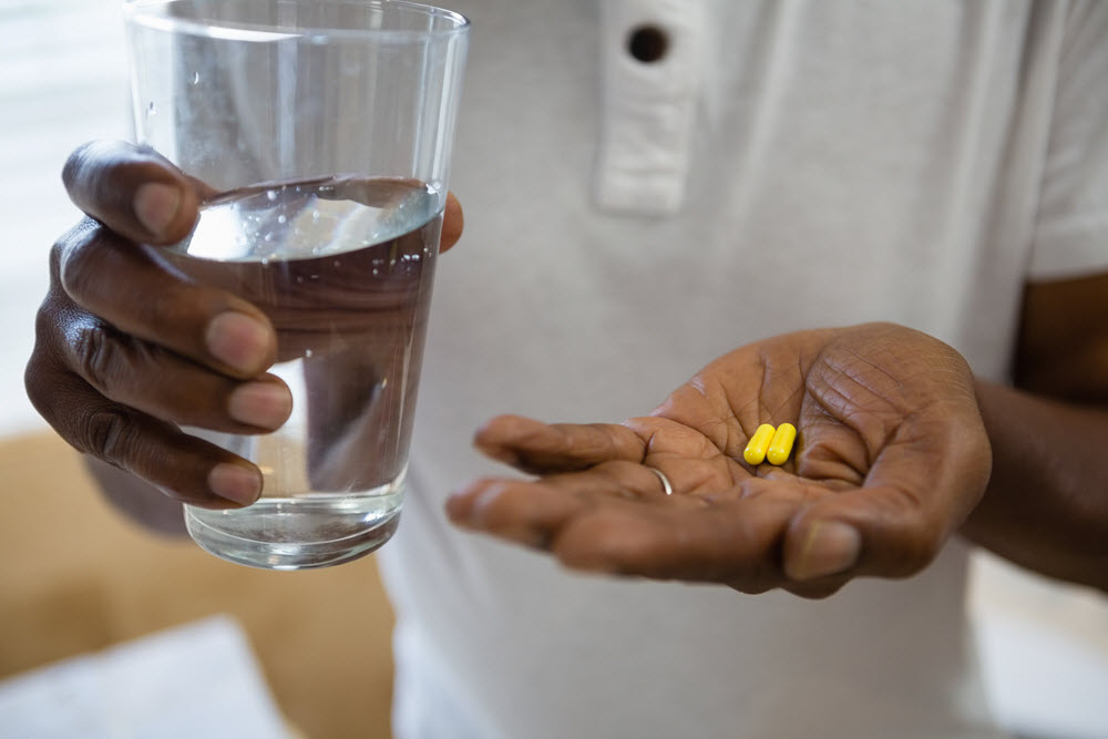 man holding pills