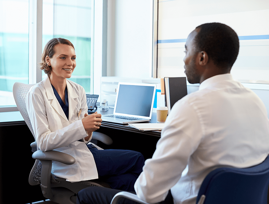 Doctor in consultation with male patient