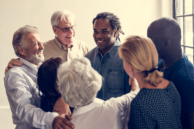 group of diverse people giving each other support