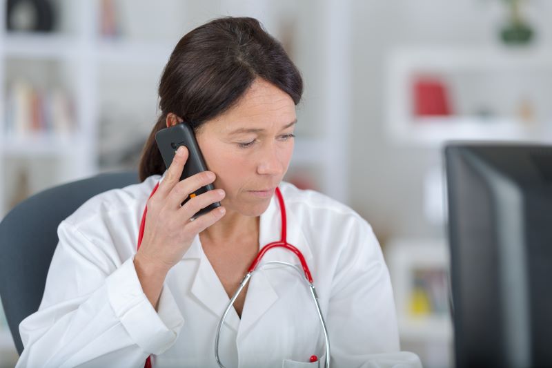 Young doctor talking on the phone