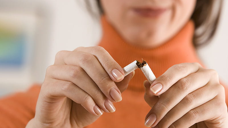 A close-up of a woman breaking a cigarette. A close-up of a woman breaking a cigarette.