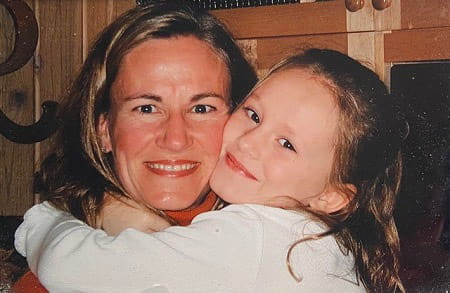 Isabella Zini being hugged by a young child