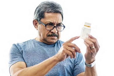 man looking at a prescription man looking at a prescription