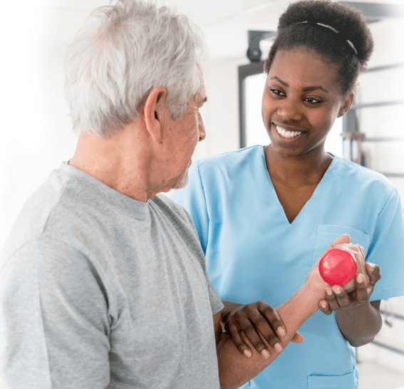 Rehab professional helping older man with therapy