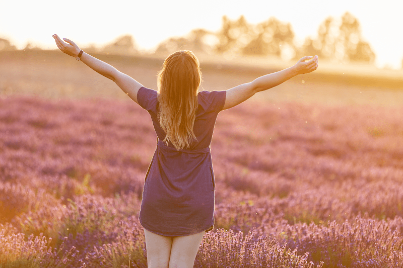 happy woman relaxing in a field