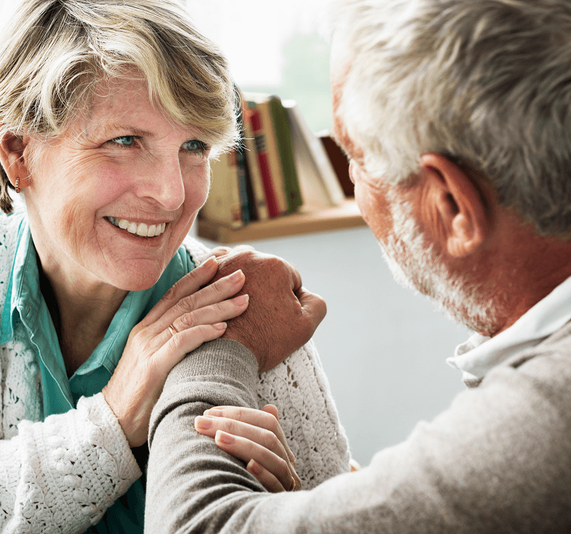 Affectionate older couple holding hands