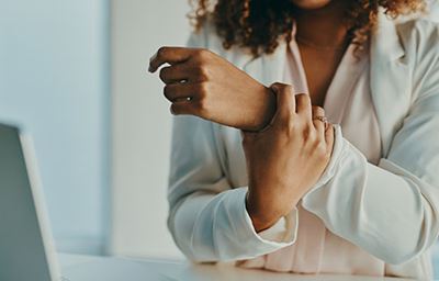 Woman holding her arm