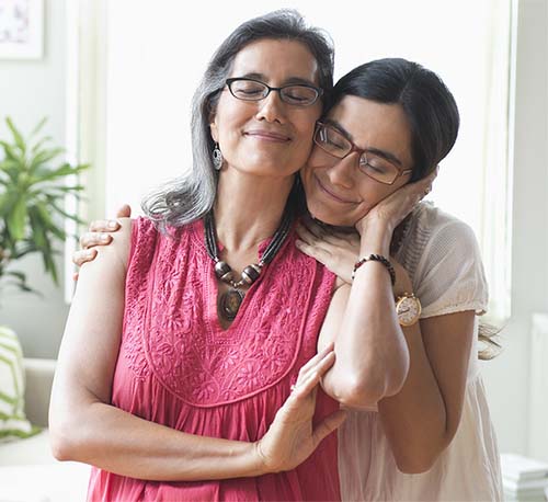 Mother and daughter standing together