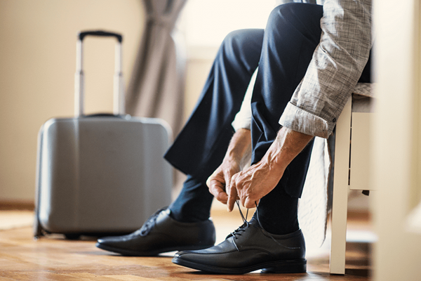 man sitting down tying his shoes man sitting down tying his shoes