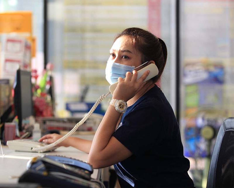 Masked woman talking on the phone